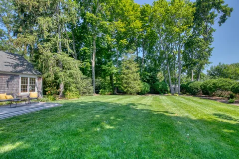 a backyard of a house with table and chairs