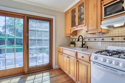 a kitchen with stainless steel appliances granite countertop a stove and a sink