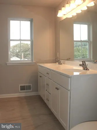 a bathroom with a sink and a window