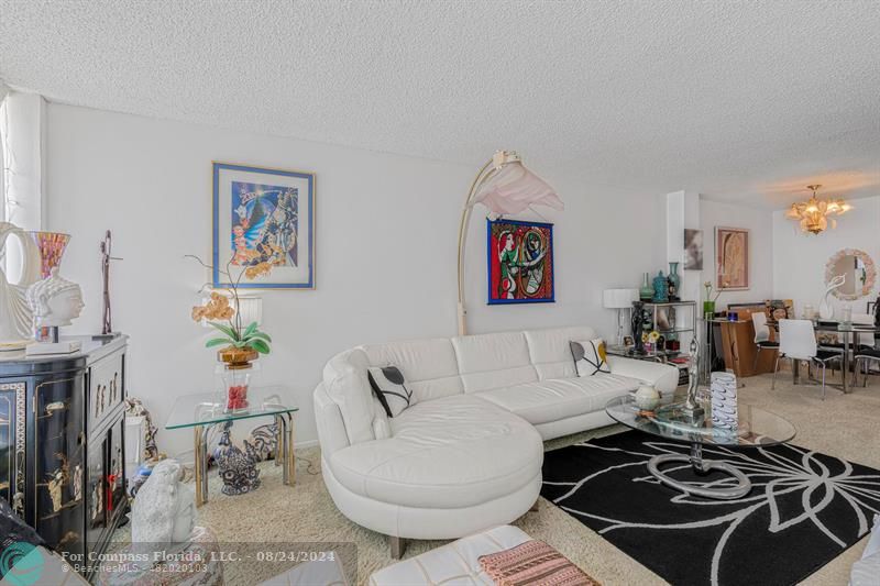 2000 Atlantic Shores Boulevard, Unit 503 Hallandale Beach, FL 33009 - Photo 1 of 21 a living room with furniture and a flat screen tv