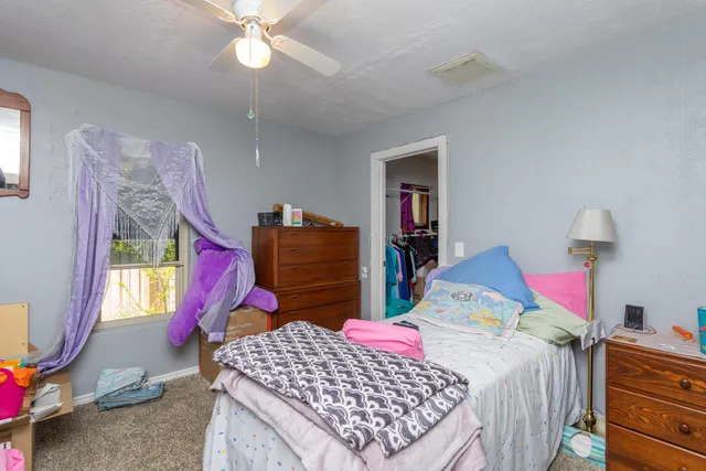 a bedroom with bed and window