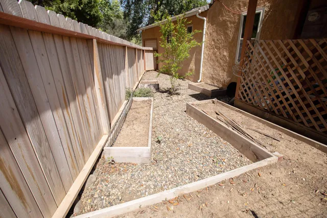 a view of a balcony with wooden floor and fence