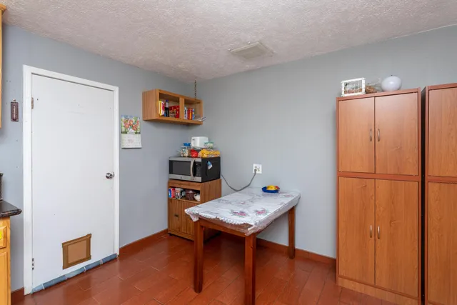 a area with a table and a bookshelf