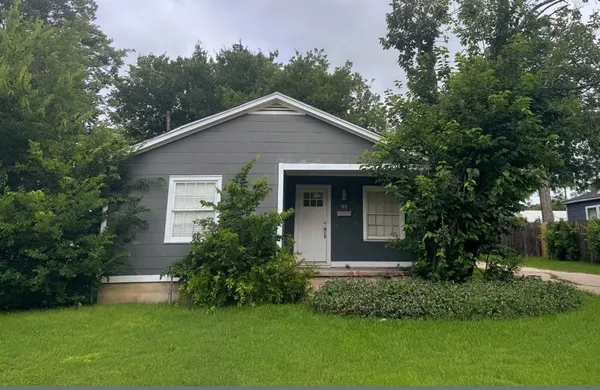 a front view of house with garden