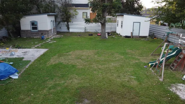 a view of a backyard with white house and a yard