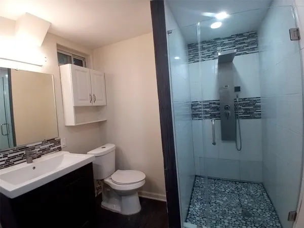 a bathroom with a sink toilet and shower