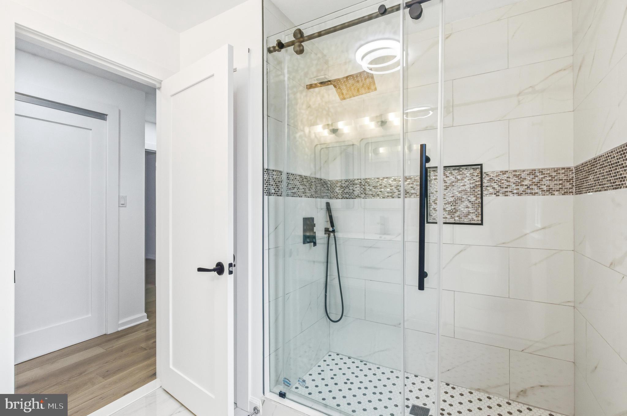 201 Church Road Devon, PA 19333 - Photo 12 of 21 a bathroom with a glass shower door