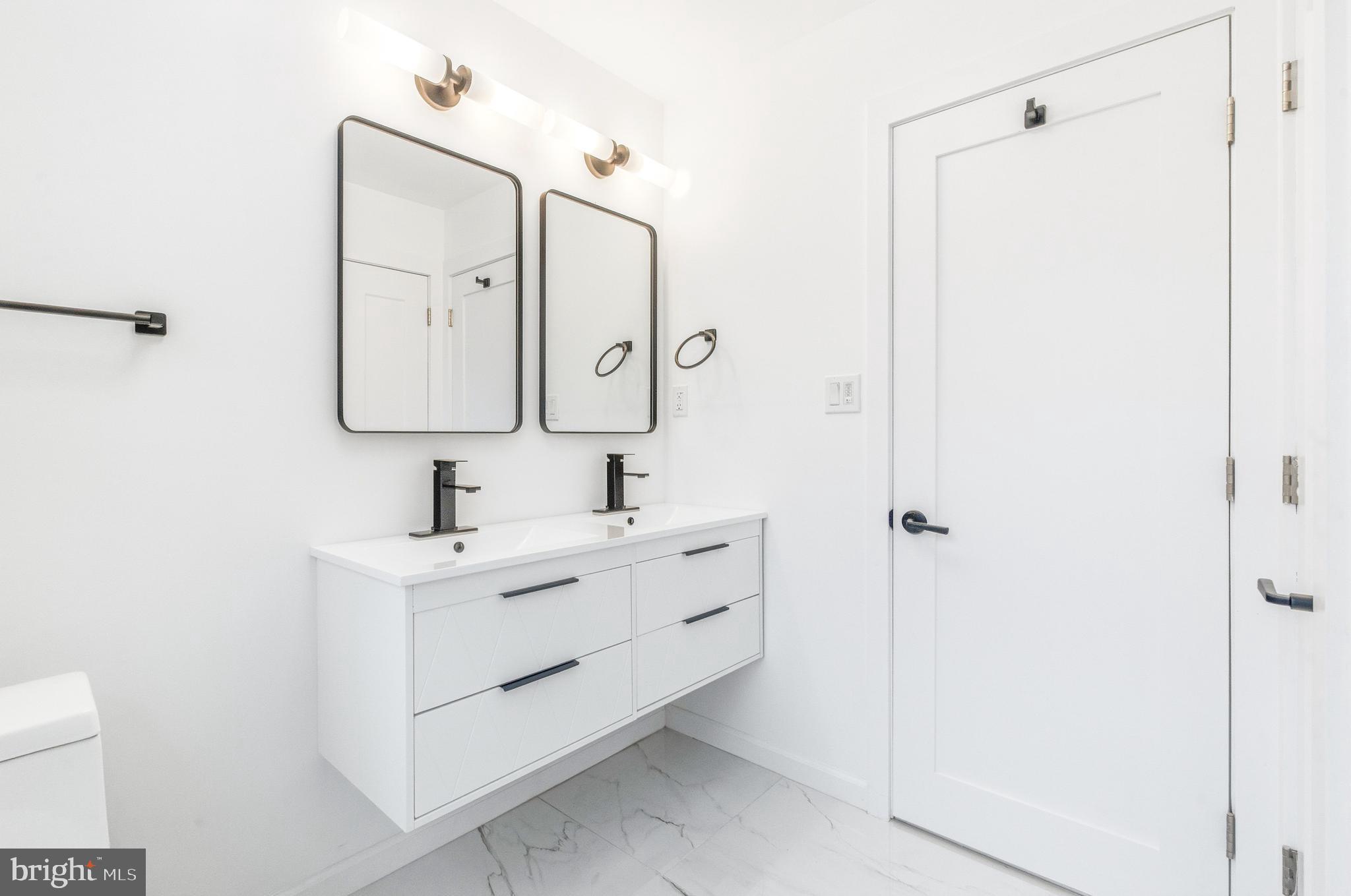 201 Church Road Devon, PA 19333 - Photo 13 of 21 a bathroom with a double vanity sink mirror and
