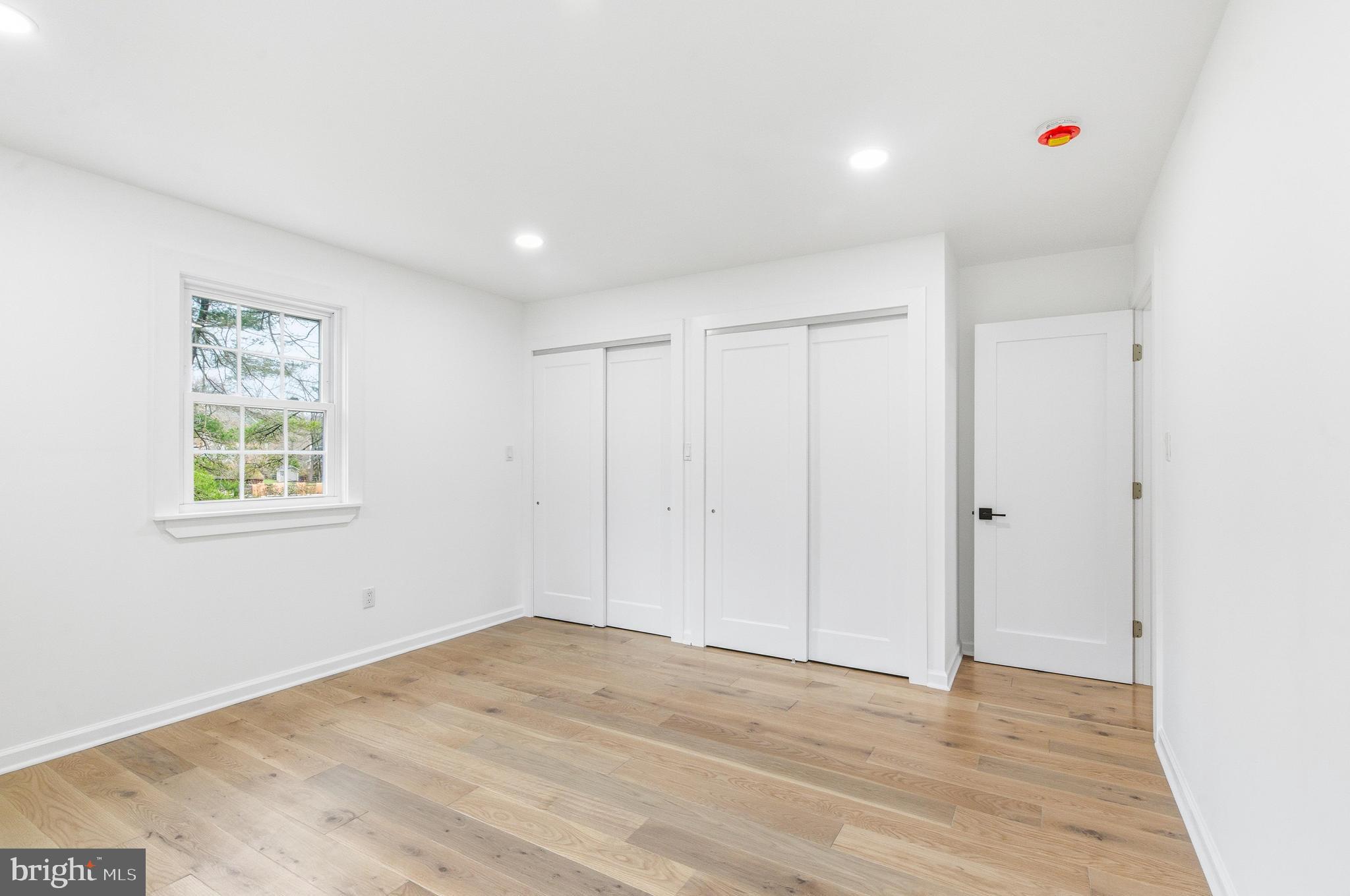 201 Church Road Devon, PA 19333 - Photo 17 of 21 a view of empty room with window and wooden floor