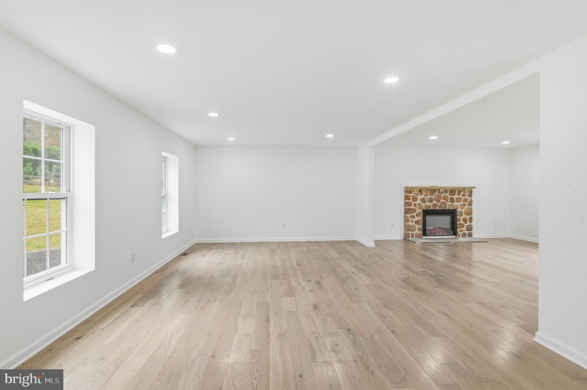 201 Church Road Devon, PA 19333 - Photo 7 of 21 an empty room with wooden floor and windows