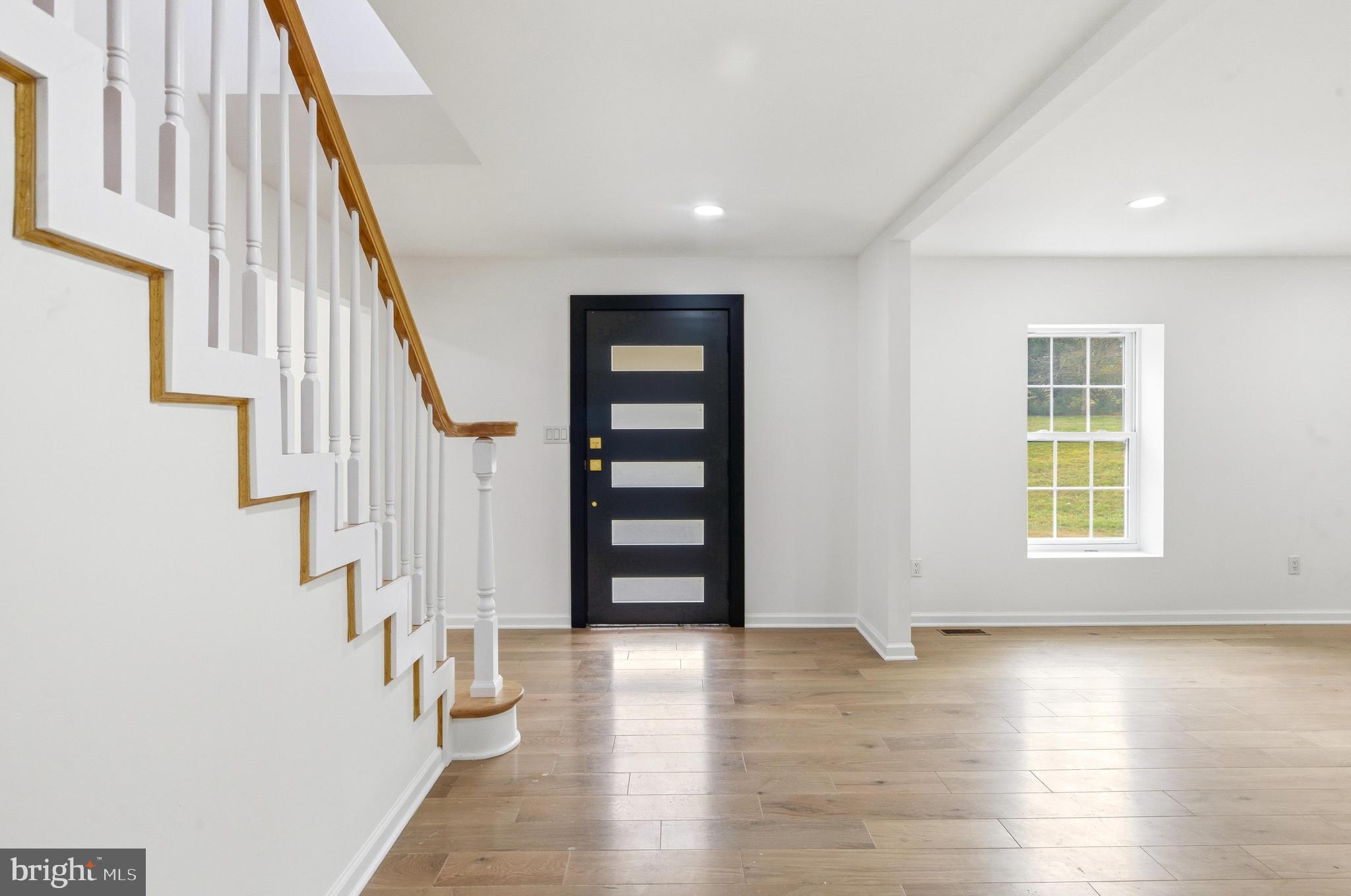 201 Church Road Devon, PA 19333 - Photo 8 of 21 a view of an entryway with wooden floor and stairs