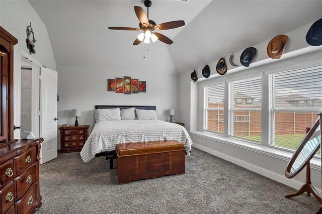 a spacious bedroom with a bed and a window