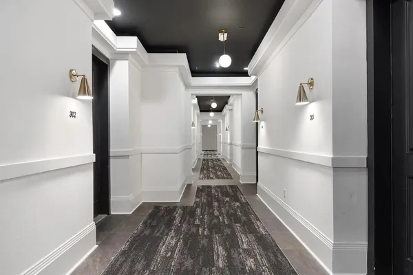 a room with a rug and a fireplace