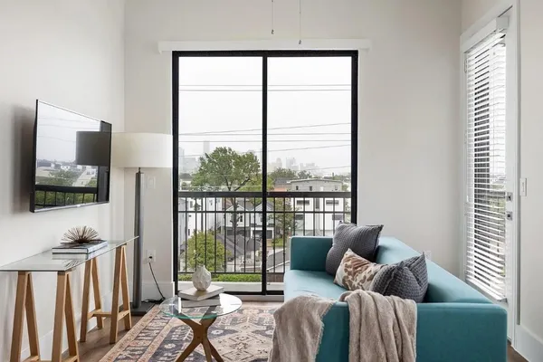 a living room with furniture and a large window