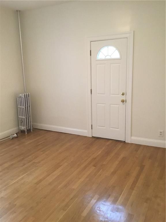 9307 3rd Avenue Brooklyn, NY 11209 - Photo 18 of 23 a view of an empty room and wooden floor