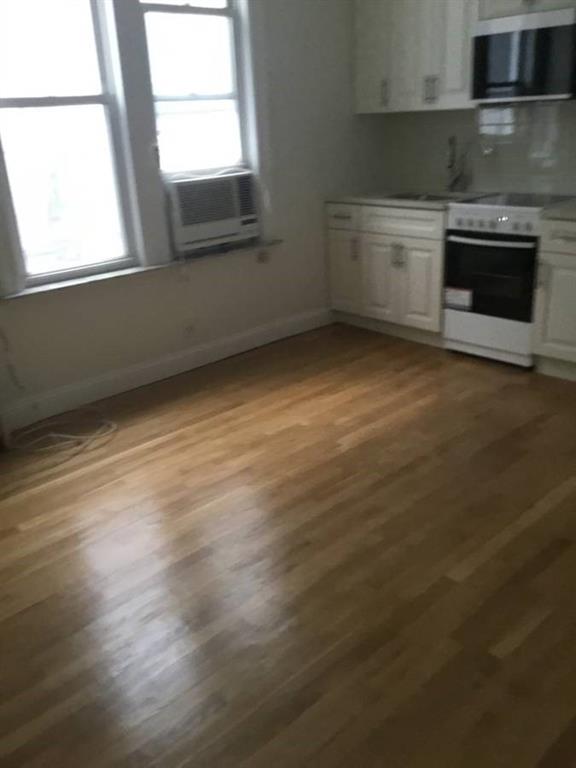 9307 3rd Avenue Brooklyn, NY 11209 - Photo 5 of 23 an empty room with wooden floor and windows