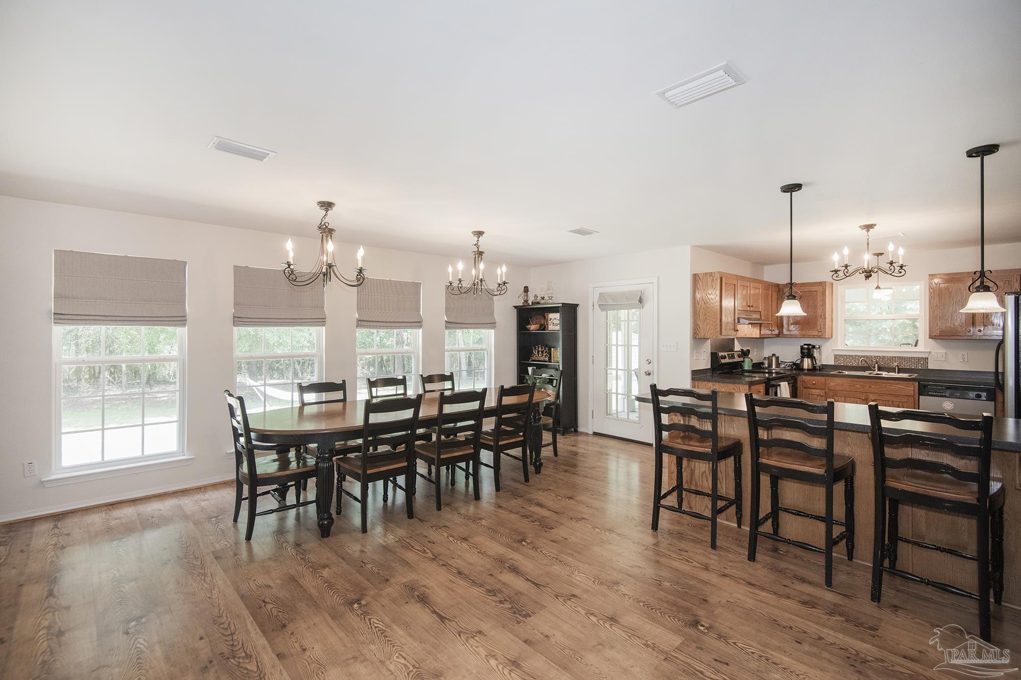 8501 Highway 97 Walnut Hill, FL 32568 - Photo 11 of 55 a view of a dining room with furniture window and wooden floor