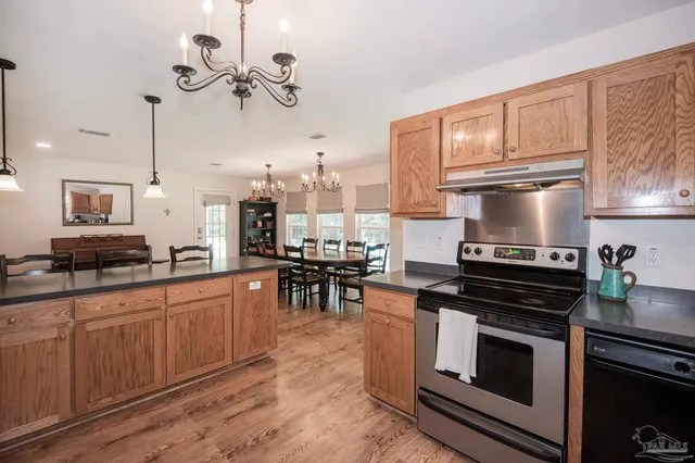 a view of a kitchen with dining room and wooden floor
