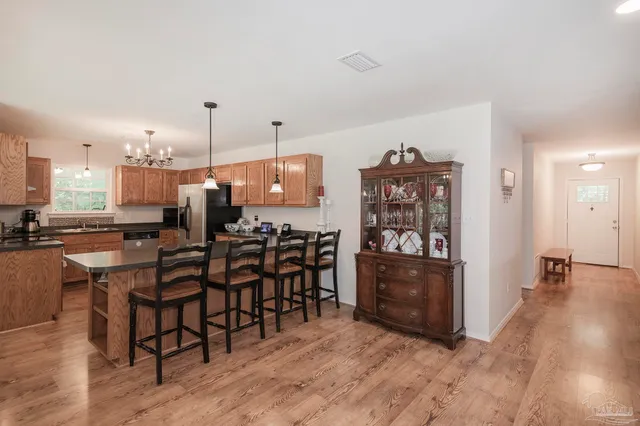a view of a dining room with furniture and chandelier