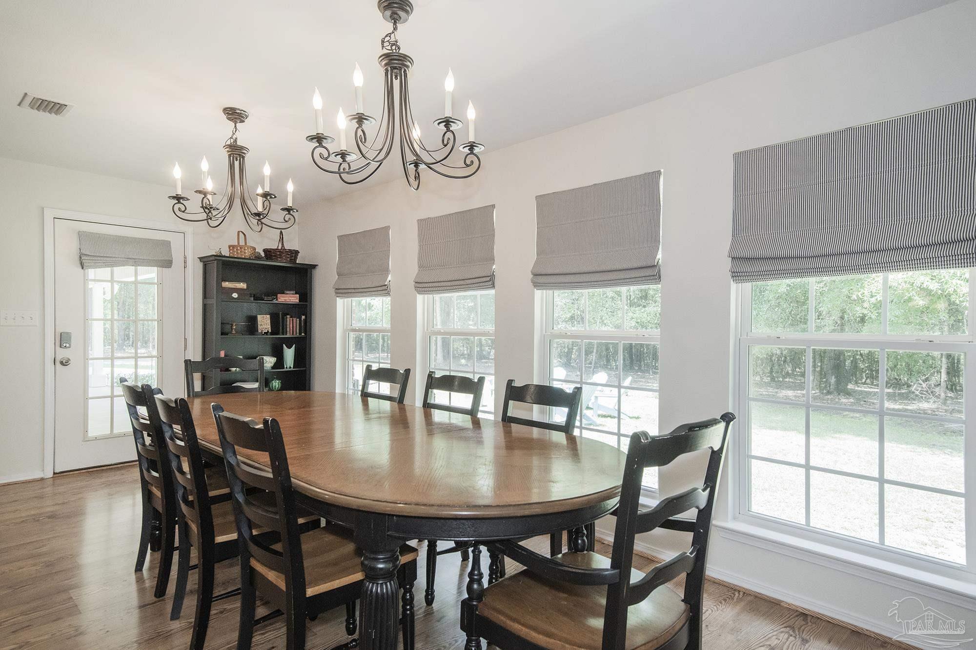 8501 Highway 97 Walnut Hill, FL 32568 - Photo 17 of 55 a view of a dining room with furniture window and wooden floor