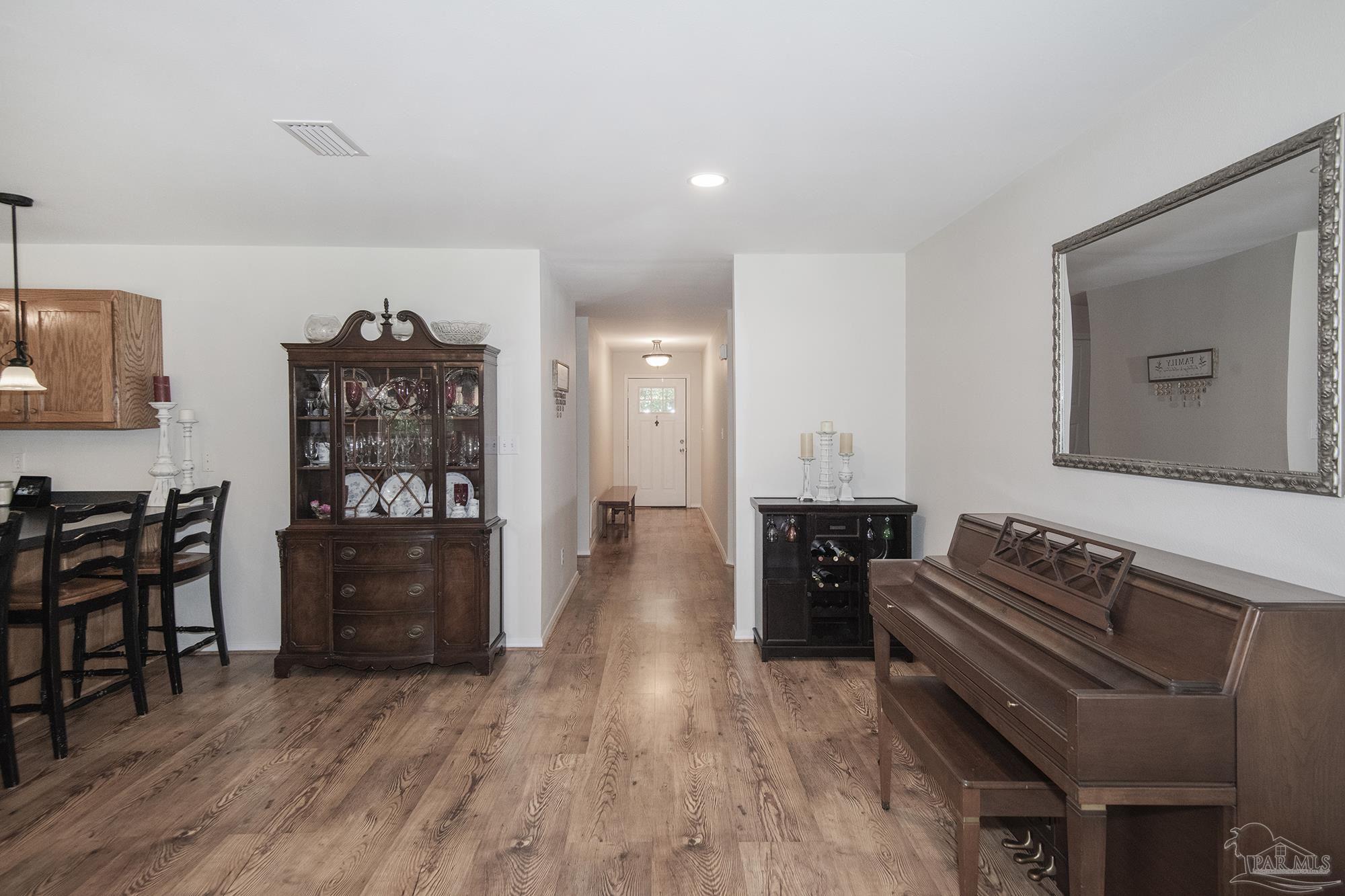 8501 Highway 97 Walnut Hill, FL 32568 - Photo 18 of 55 a living room with furniture and wooden floor