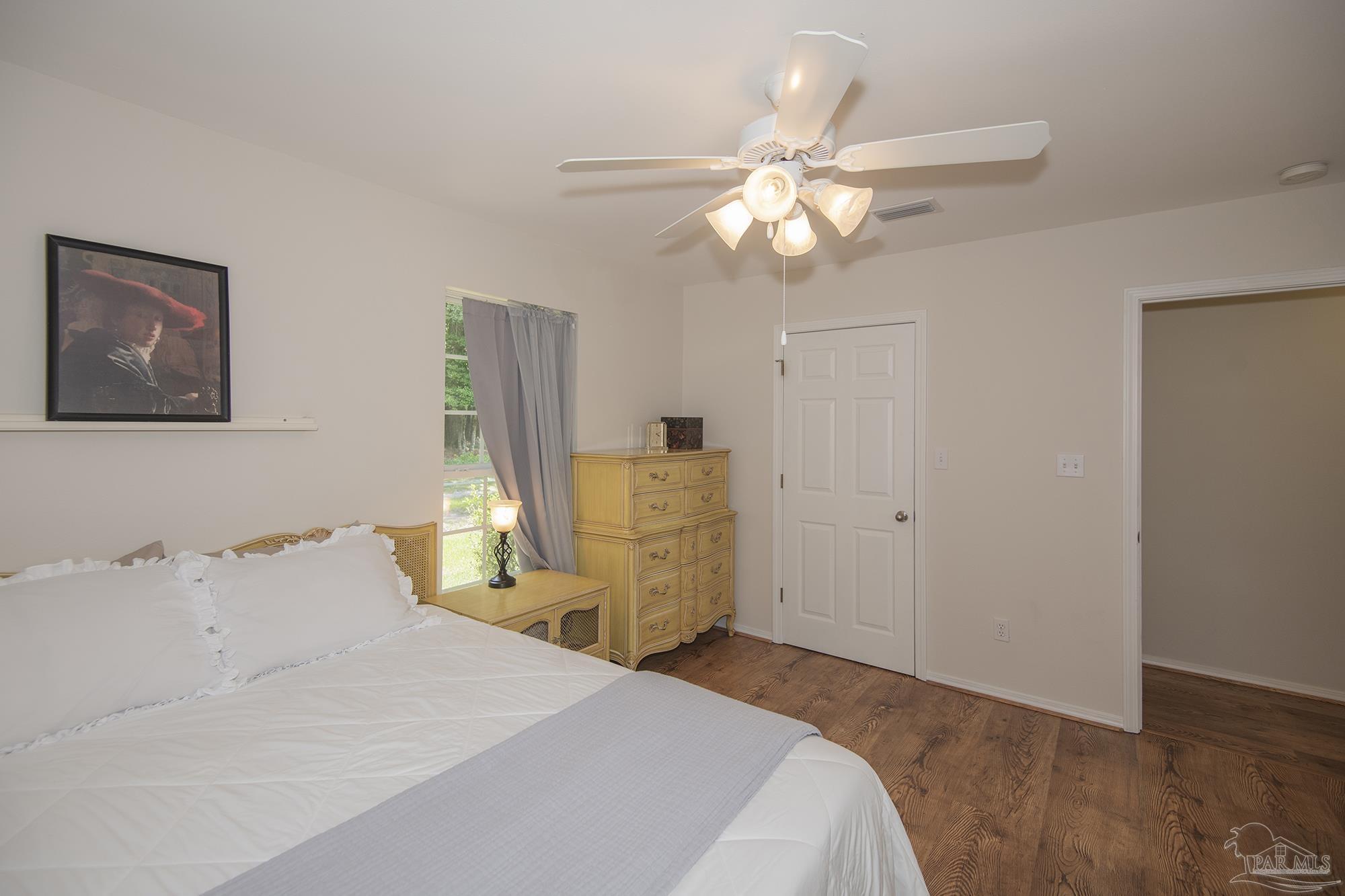 8501 Highway 97 Walnut Hill, FL 32568 - Photo 24 of 55 a bedroom with a bed and a chandelier