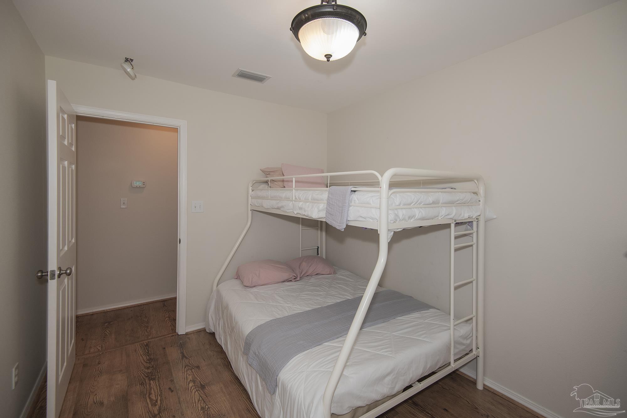 8501 Highway 97 Walnut Hill, FL 32568 - Photo 26 of 55 a bed room with a bed and a window