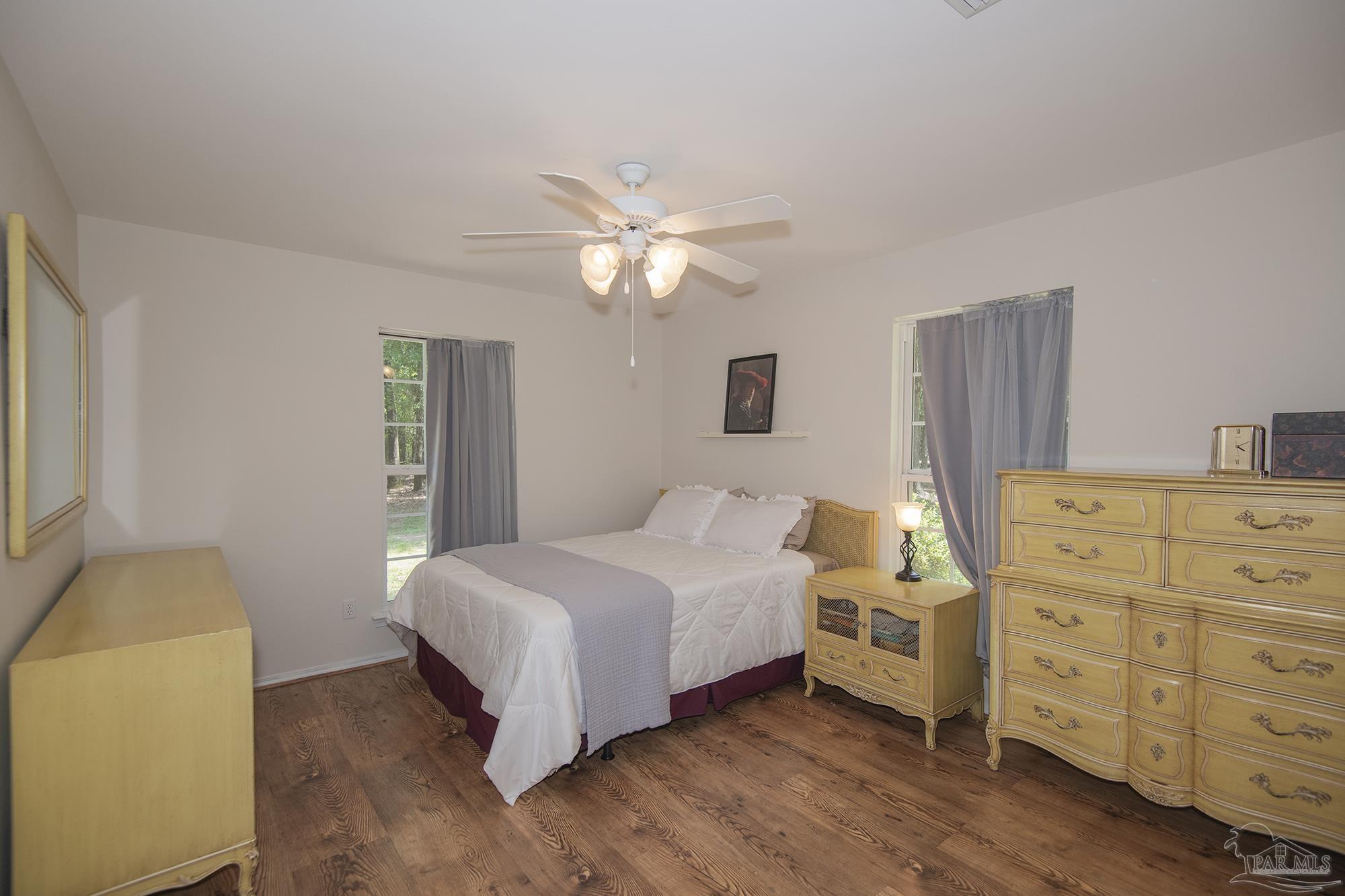 8501 Highway 97 Walnut Hill, FL 32568 - Photo 28 of 55 a bedroom with a bed and a chandelier