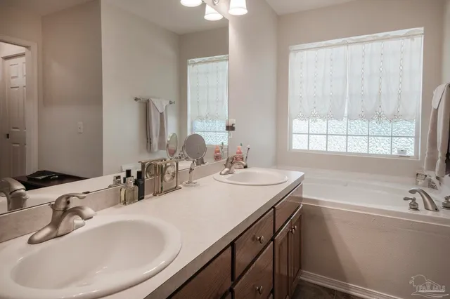 a bathroom with a double vanity sink and a mirror