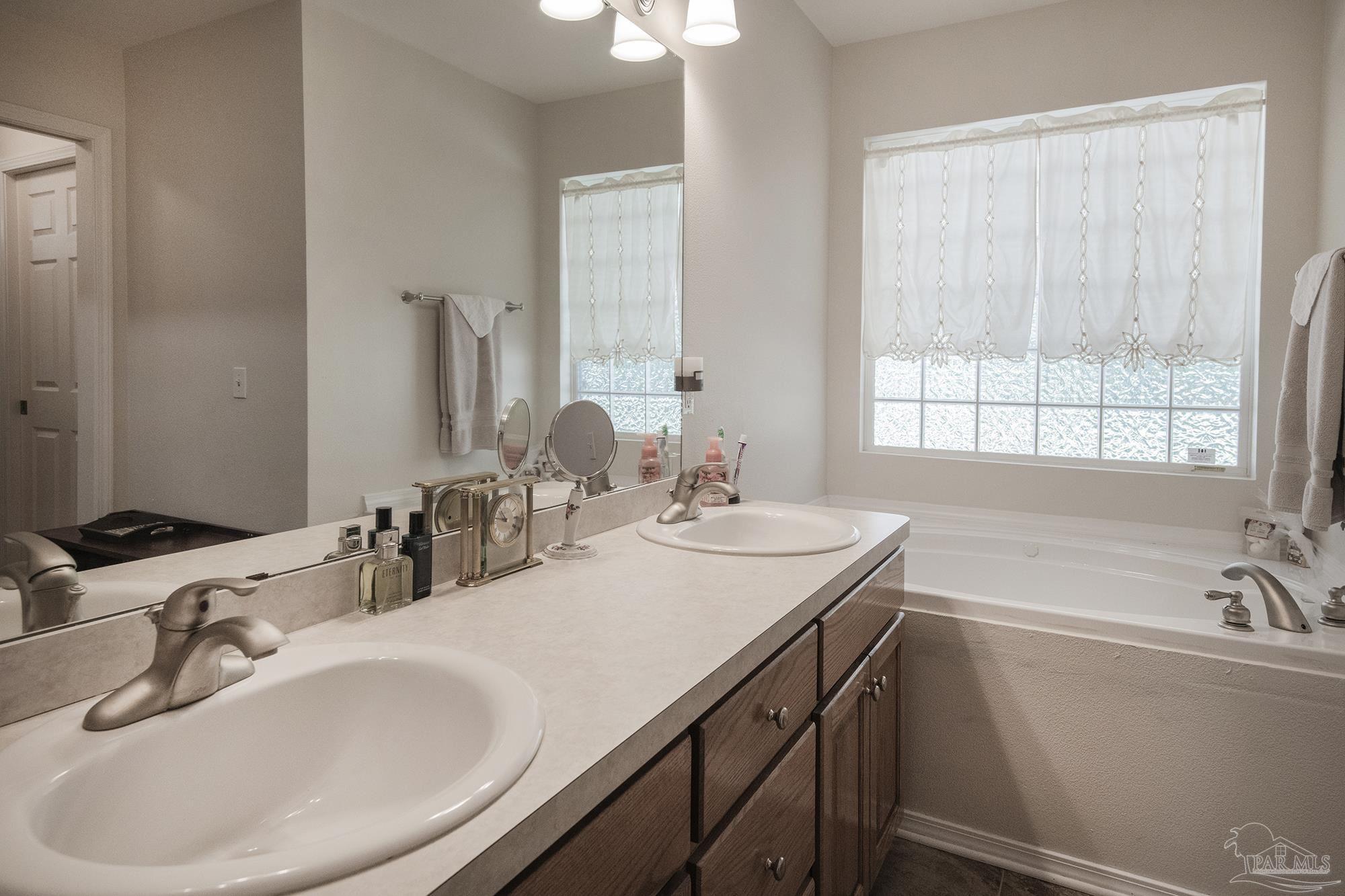 8501 Highway 97 Walnut Hill, FL 32568 - Photo 34 of 55 a bathroom with a sink and a bathtub