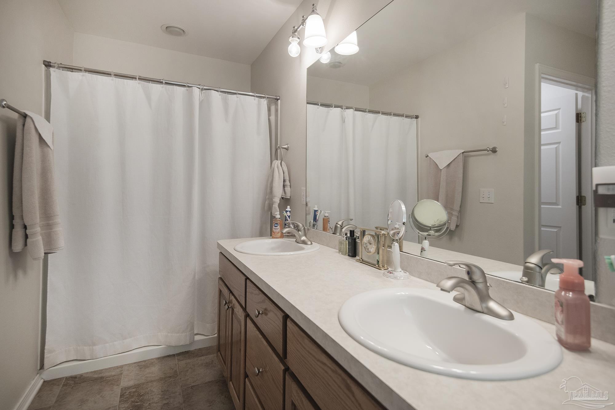 8501 Highway 97 Walnut Hill, FL 32568 - Photo 35 of 55 a bathroom with a double vanity sink and a mirror