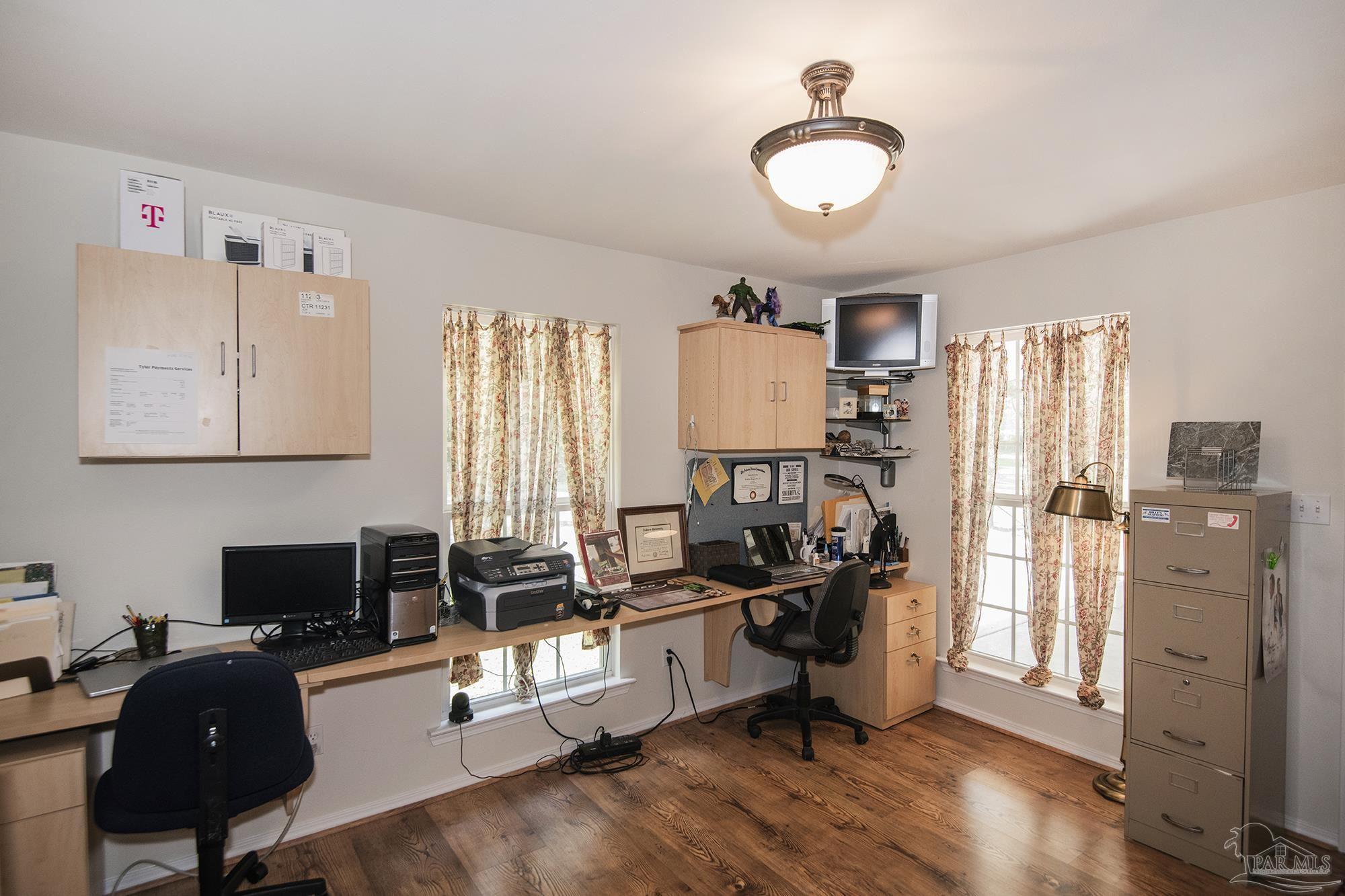 8501 Highway 97 Walnut Hill, FL 32568 - Photo 39 of 55 a view of a workspace with furniture and a window