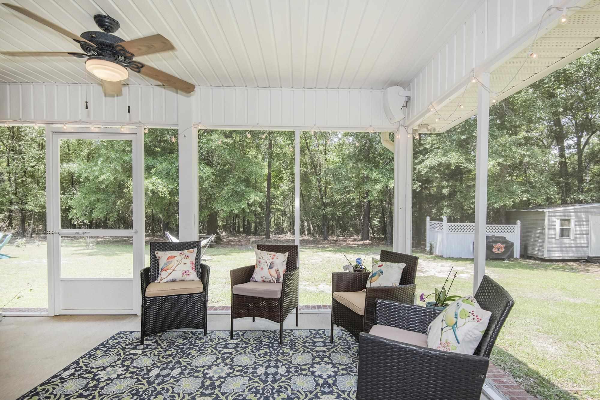 8501 Highway 97 Walnut Hill, FL 32568 - Photo 43 of 55 a living room with furniture and a large window