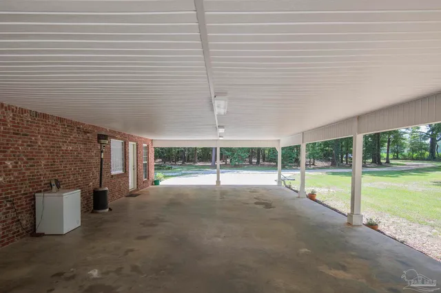 a view of a backyard with swimming pool and sitting area