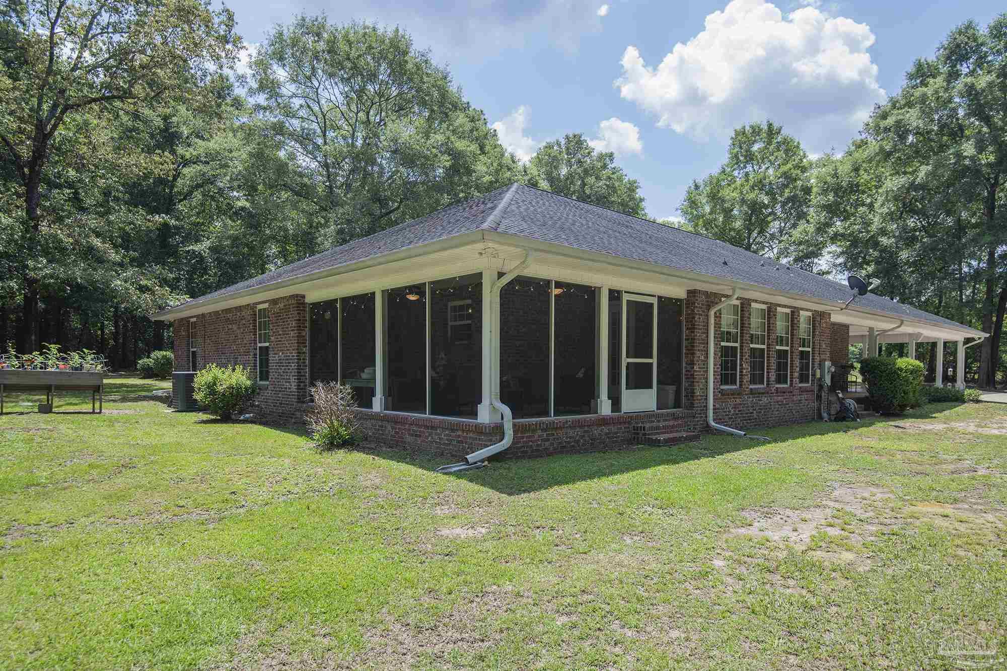 8501 Highway 97 Walnut Hill, FL 32568 - Photo 48 of 55 a view of a house with a yard and sitting area