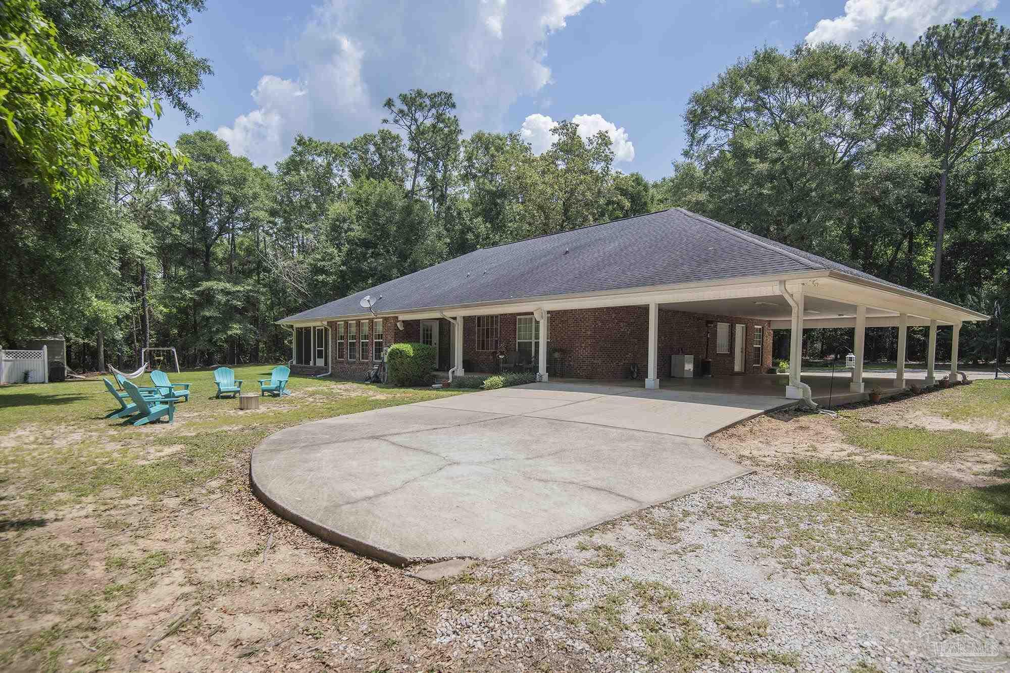 8501 Highway 97 Walnut Hill, FL 32568 - Photo 49 of 55 a front view of a house with a garden