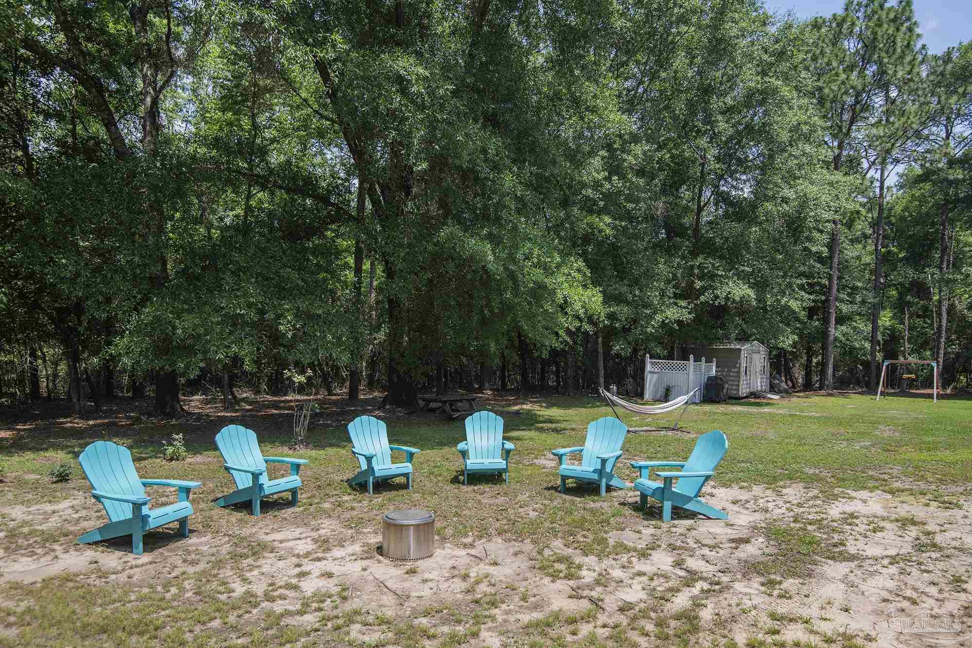 8501 Highway 97 Walnut Hill, FL 32568 - Photo 50 of 55 a view of a backyard with swimming pool and sitting area