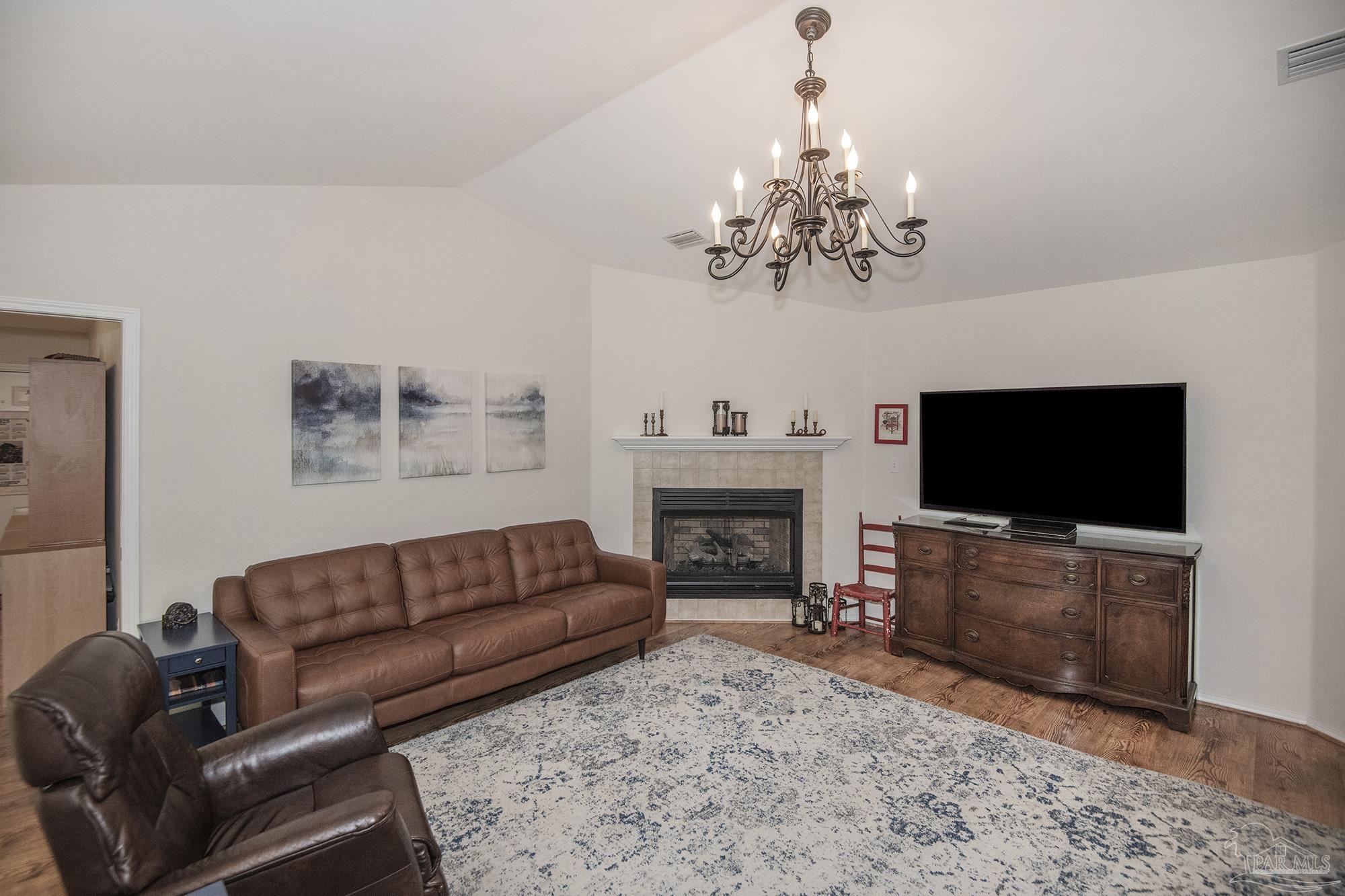 8501 Highway 97 Walnut Hill, FL 32568 - Photo 7 of 55 a living room with furniture a flat screen tv and a fireplace