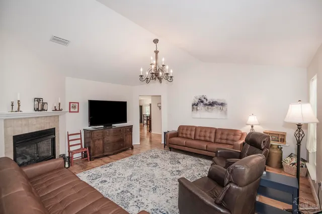 a living room with furniture and a chandelier
