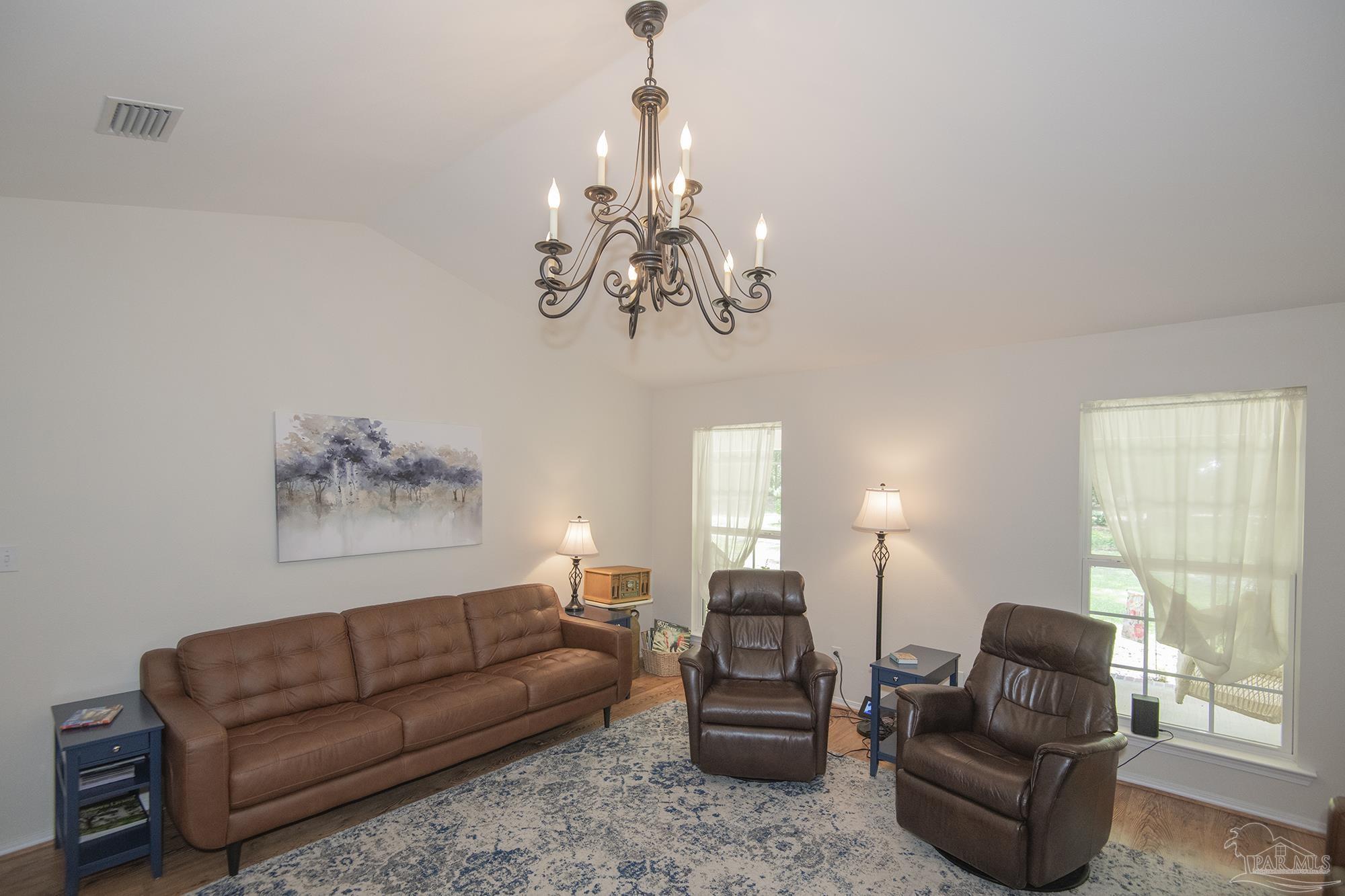 8501 Highway 97 Walnut Hill, FL 32568 - Photo 9 of 55 a living room with furniture and a chandelier