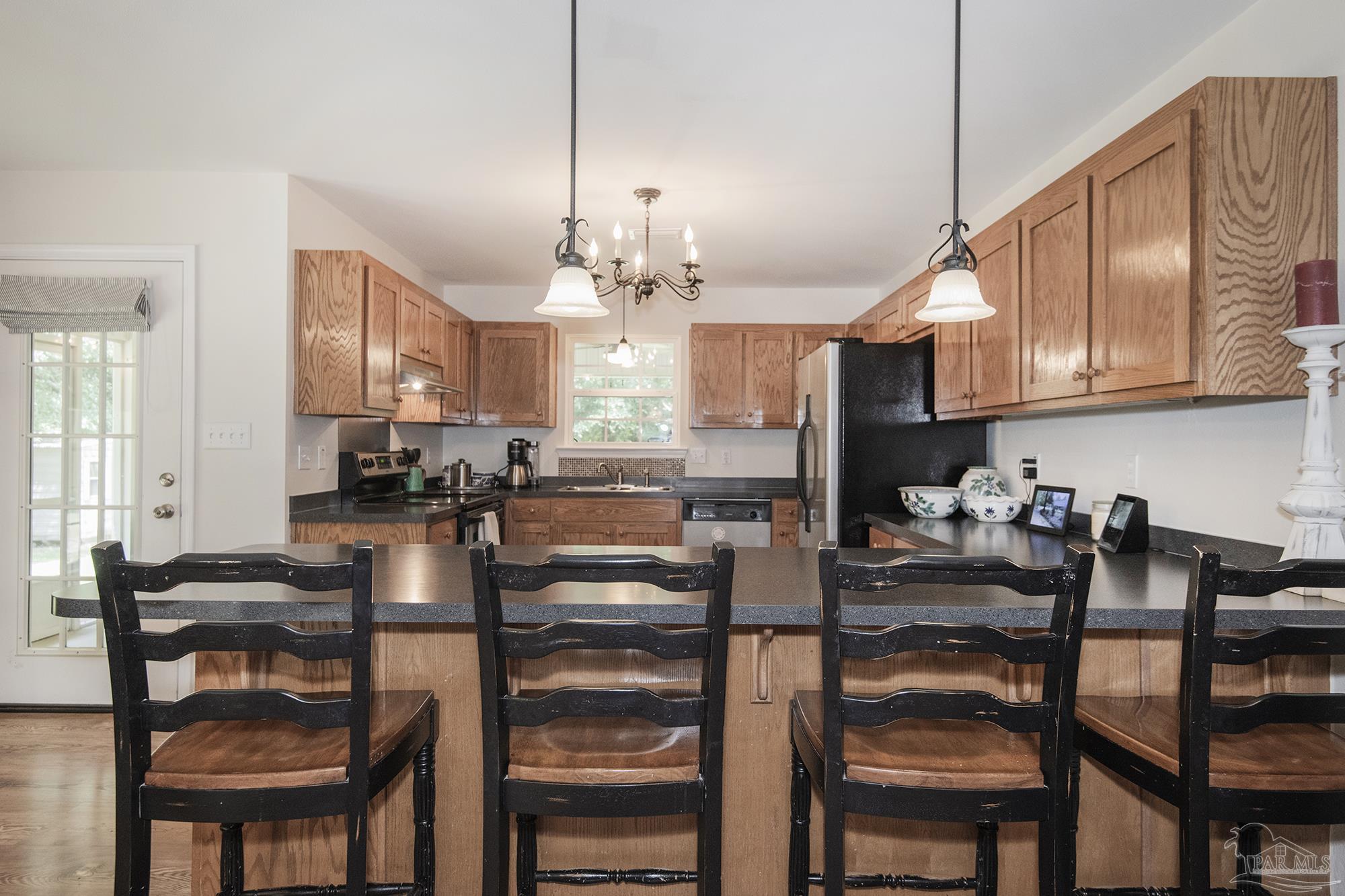 8501 Highway 97 Walnut Hill, FL 32568 - Photo 10 of 55 a kitchen with sink and chairs