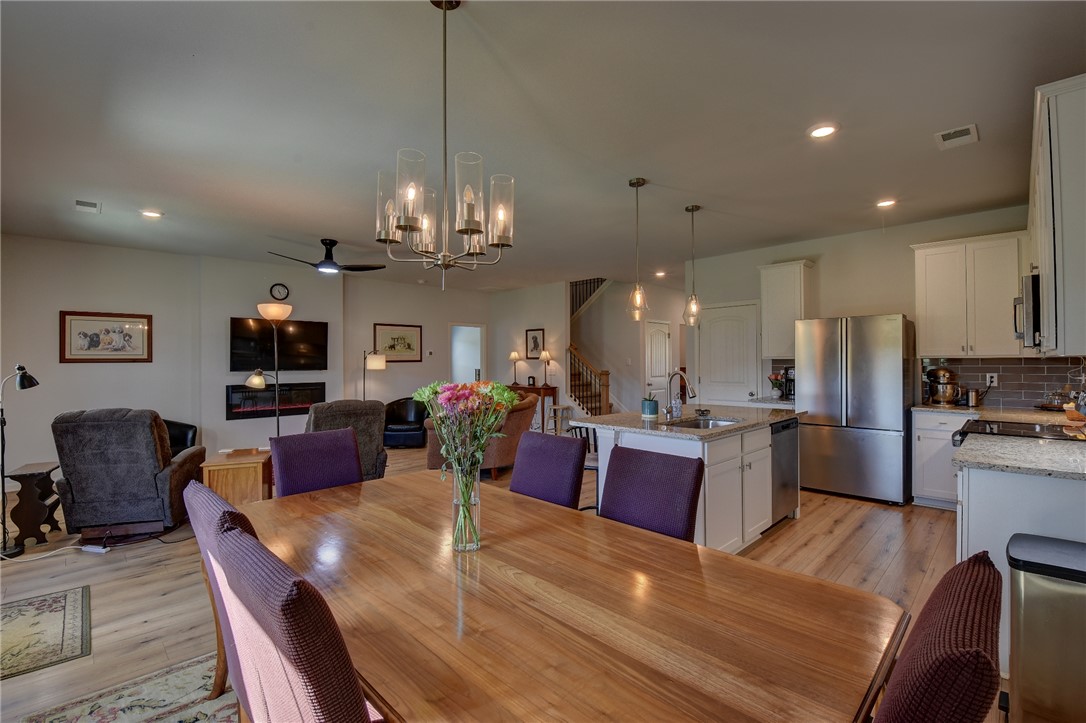 220 Clinkscales Road Anderson, SC 29624 - Photo 33 of 33 An open floorplan seamlessly connects the dining area to a modern kitchen and living space.