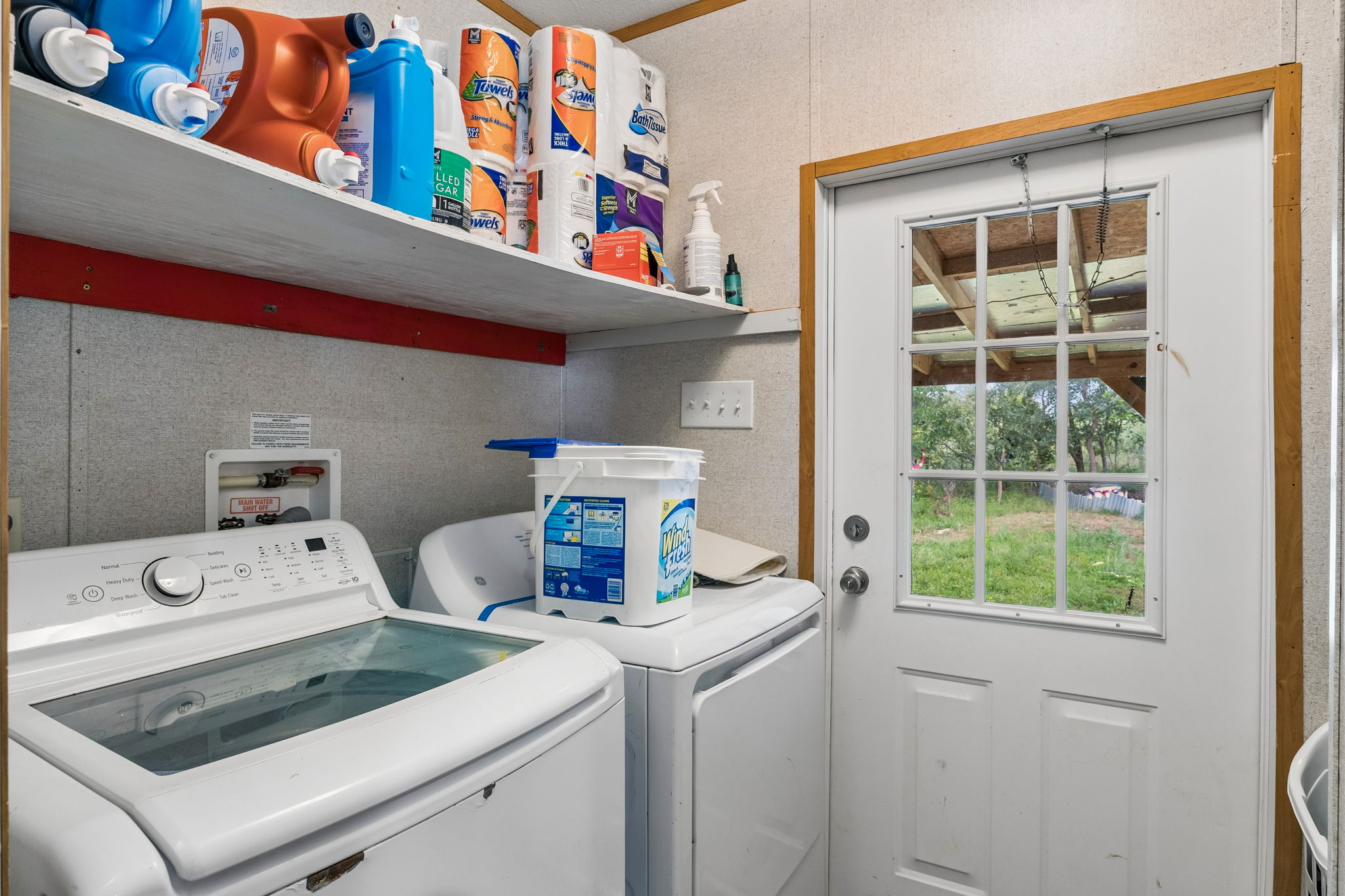 253 North County Line Road, Unit C Elgin, TX 78621 - Photo 13 of 39 Functional laundry room, equipped with appliances and convenient access to the outdoors.