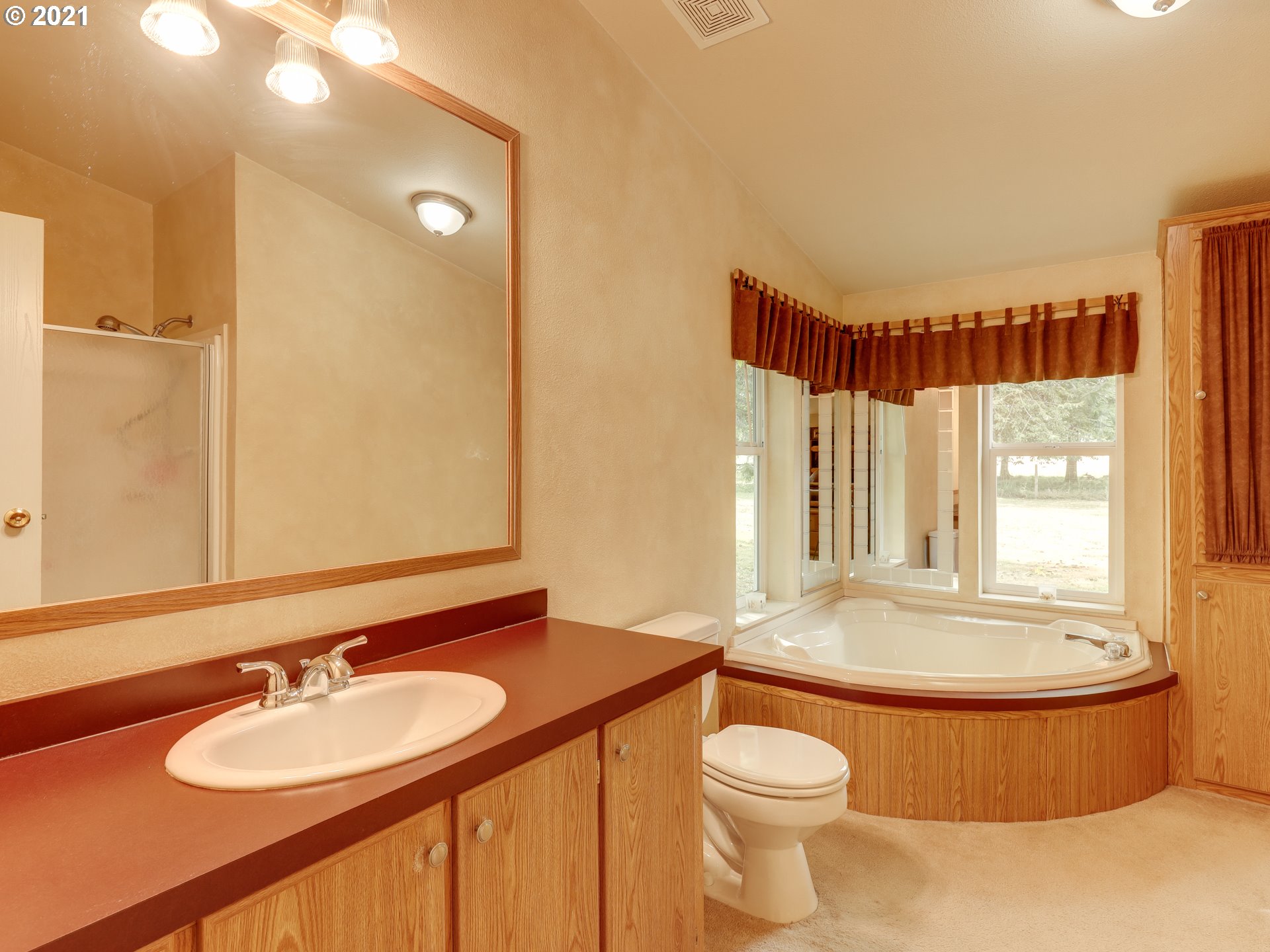 44644 Southeast Coalman Road Sandy, OR 97055 - Photo 14 of 31 a bathroom with a granite countertop sink and a mirror