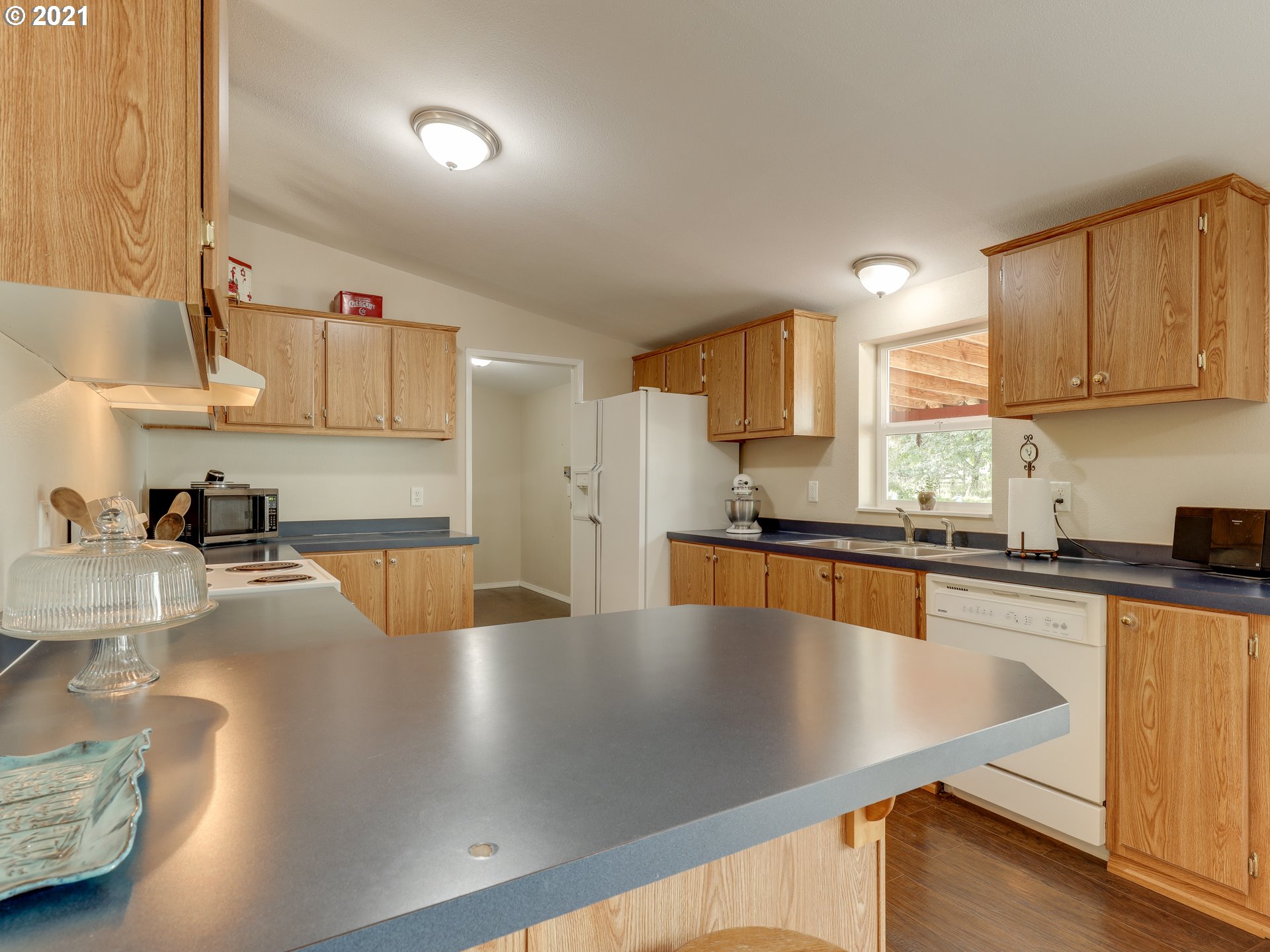 44644 Southeast Coalman Road Sandy, OR 97055 - Photo 9 of 31 a kitchen with stainless steel appliances granite countertop a sink a stove and a refrigerator