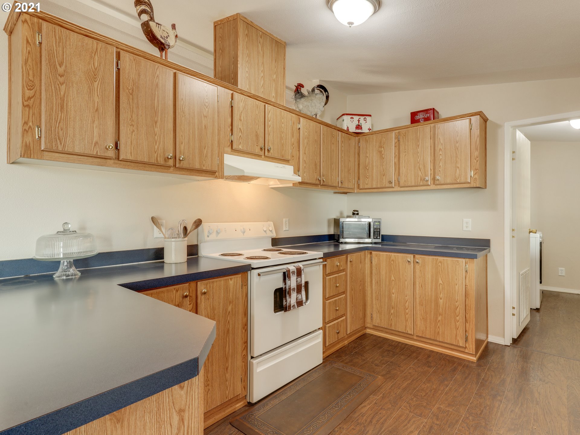 44644 Southeast Coalman Road Sandy, OR 97055 - Photo 10 of 31 a kitchen with stainless steel appliances granite countertop a stove a sink and a white cabinets