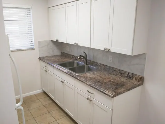 a kitchen with a sink and cabinets