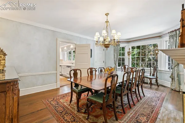 a view of a dining room with furniture wooden floor and chandelier
