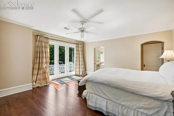 a bedroom with a large bed and a large window