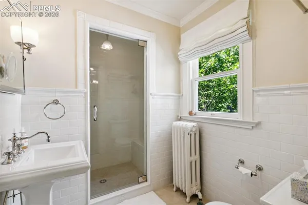 a bathroom with a shower and a sink